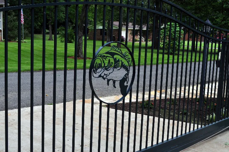 Black metal gate with decorative circular emblem